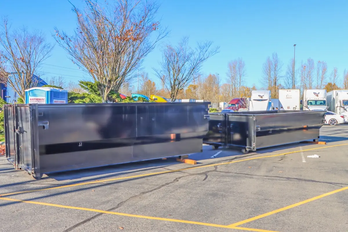 Professional dumpster rental service with roll-off container on residential driveway in Cecil